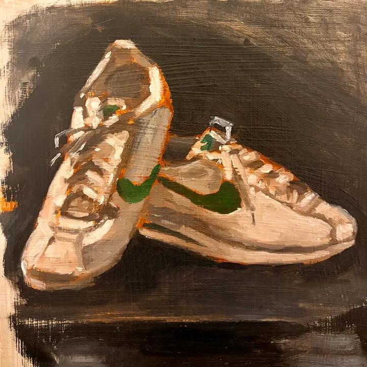 Oil painting of a pair of sneakers on a dark surface.